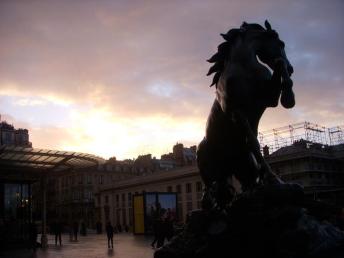 A horse statue bucks at the sunset in front of the Musée d'Orsay.